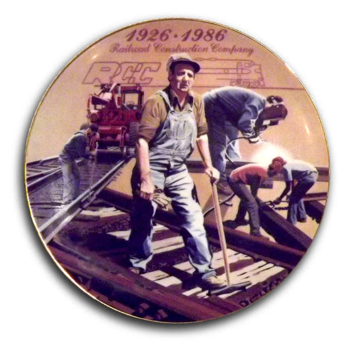 60 year celebration plate showing men working on a track