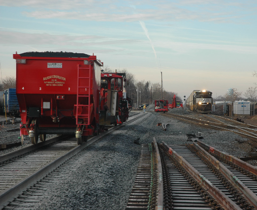 Track with red train holding coal/materials