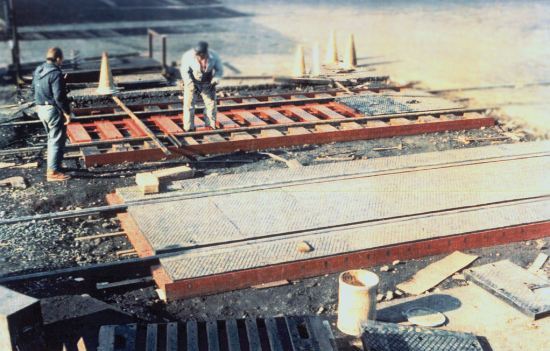 Men by the track at Ford Motor